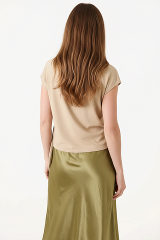 Back shot of model in stone tie-top and olive skirt