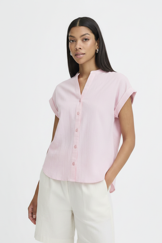 Pink shirt untucked on model